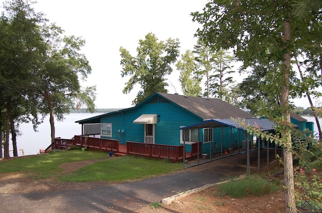 view of front of home featuring a front yard and a deck