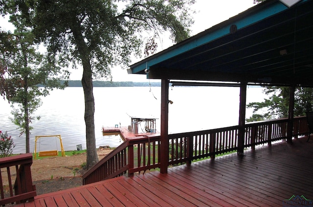 deck featuring a water view and a playground