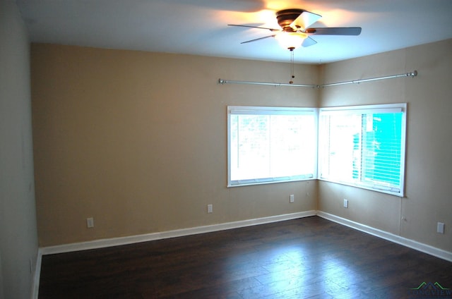 empty room featuring dark hardwood / wood-style floors and ceiling fan