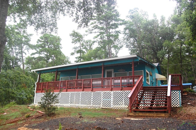 back of house featuring a wooden deck