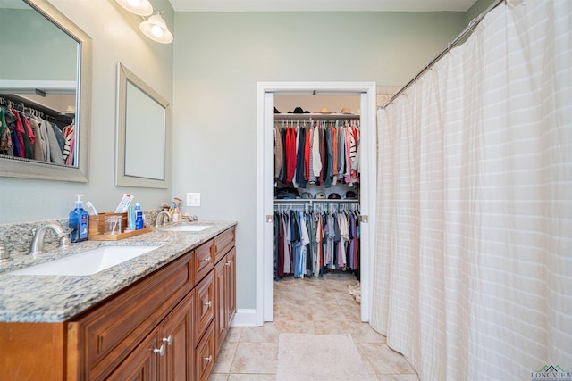 2212 Farmers Branch Rd, Diana, TX 75640 - full bathroom featuring double vanity, a spacious closet, and tile patterned flooring