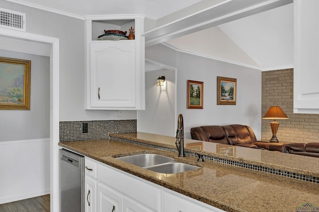 kitchen with sink, stainless steel dishwasher, dark stone countertops, dark hardwood / wood-style flooring, and white cabinetry