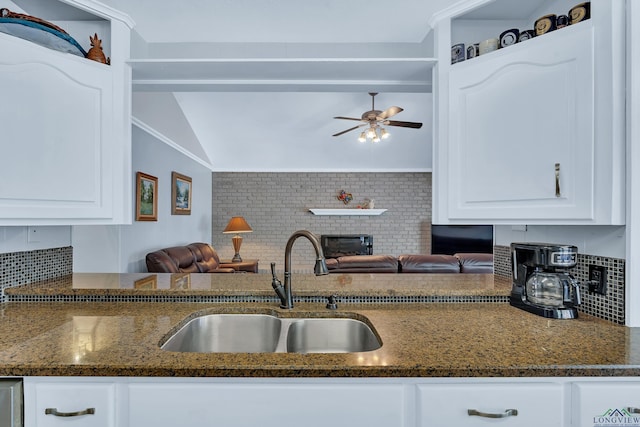 kitchen featuring white cabinets, decorative backsplash, and sink