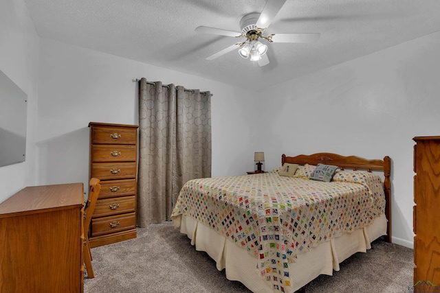 bedroom with carpet, ceiling fan, and a textured ceiling