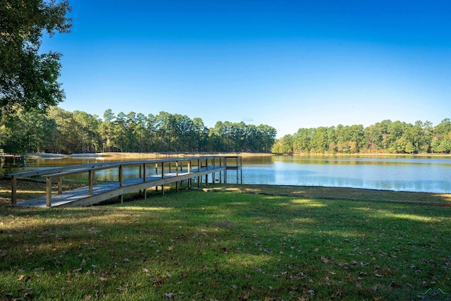 view of dock with a water view and a yard