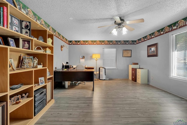 office area with ceiling fan, a textured ceiling, and hardwood / wood-style flooring