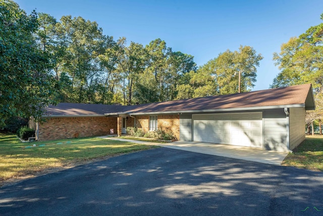 single story home with a front lawn and a garage