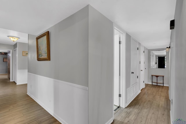 hallway with light hardwood / wood-style flooring