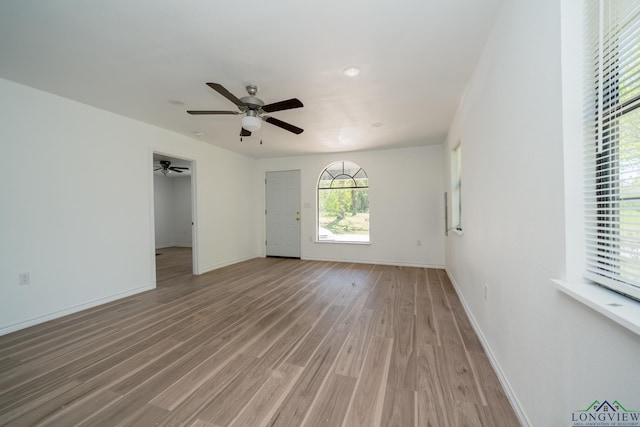 spare room featuring wood-type flooring and ceiling fan