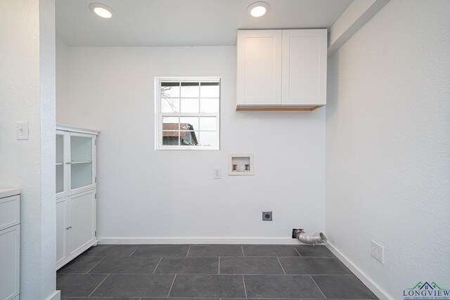 1255 County Road 4305, Naples, TX 75568 - laundry area featuring cabinet space, washer hookup, electric dryer hookup, dark tile patterned flooring, and baseboards
