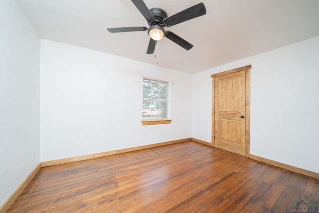 1255 County Road 4305, Naples, TX 75568 - empty room featuring wood-type flooring, baseboards, and ceiling fan