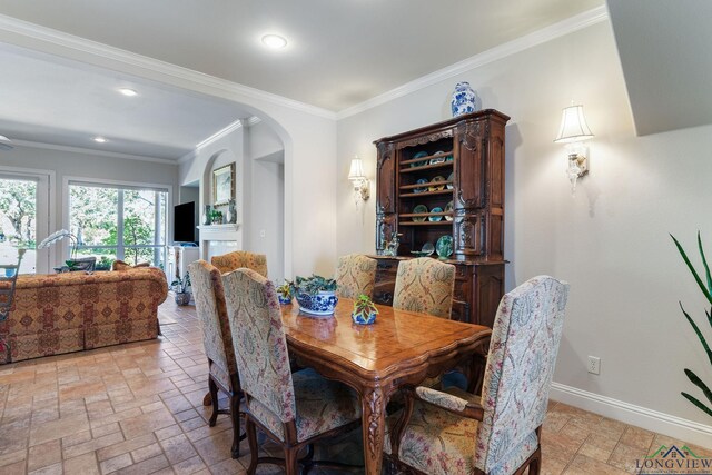 1719 Hg Mosley Pkwy, Longview, TX 75604 - dining room featuring stone tile floors, baseboards, arched walkways, recessed lighting, and ornamental molding
