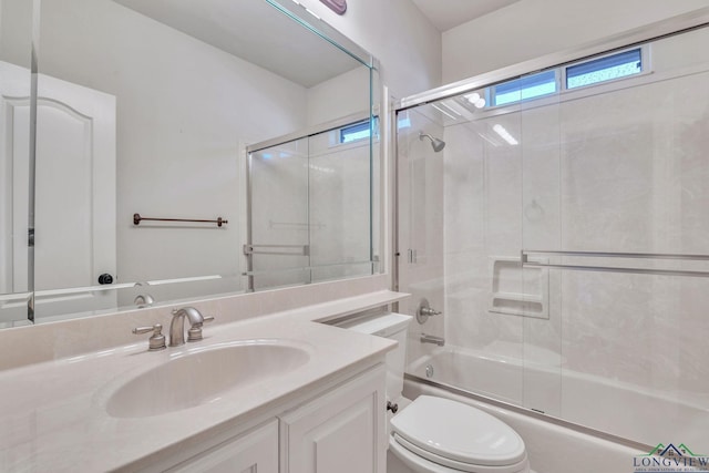 1719 Hg Mosley Pkwy, Longview, TX 75604 - bathroom featuring vanity, toilet, and combined bath / shower with glass door