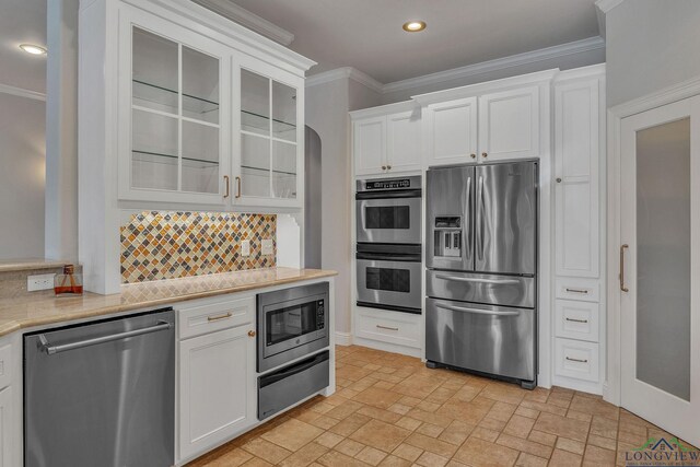 1719 Hg Mosley Pkwy, Longview, TX 75604 - dining area featuring stone tile flooring, baseboards, recessed lighting, arched walkways, and ornamental molding