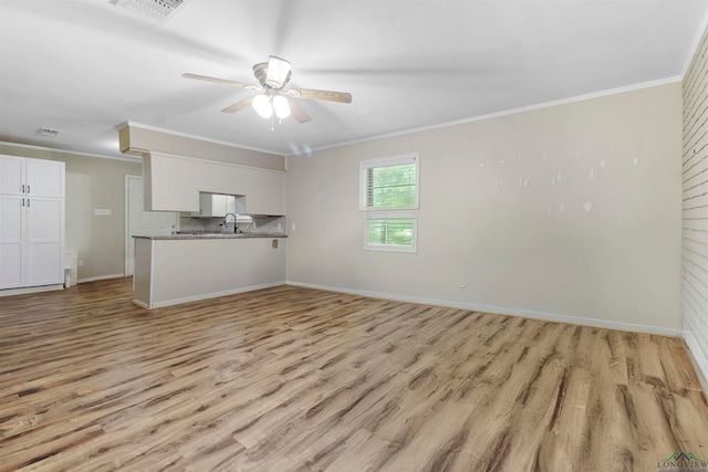 unfurnished living room with ceiling fan, crown molding, and light hardwood / wood-style flooring