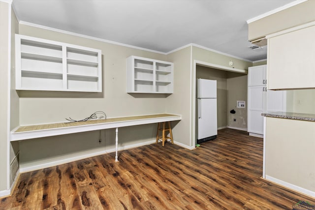 kitchen featuring white cabinets, white refrigerator, dark hardwood / wood-style flooring, and ornamental molding