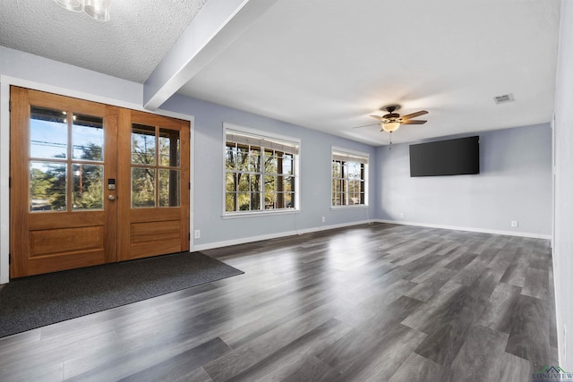 foyer entrance featuring french doors, dark hardwood / wood-style flooring, a textured ceiling, ceiling fan, and beam ceiling