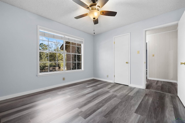 unfurnished bedroom featuring ceiling fan, dark hardwood / wood-style floors, and a textured ceiling