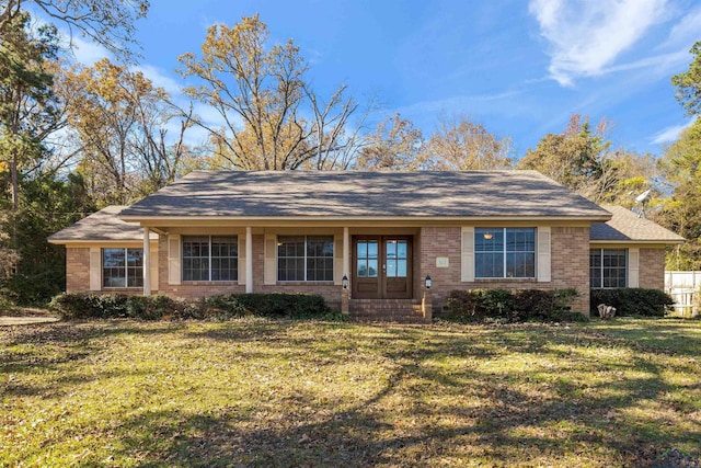 ranch-style house featuring french doors and a front lawn