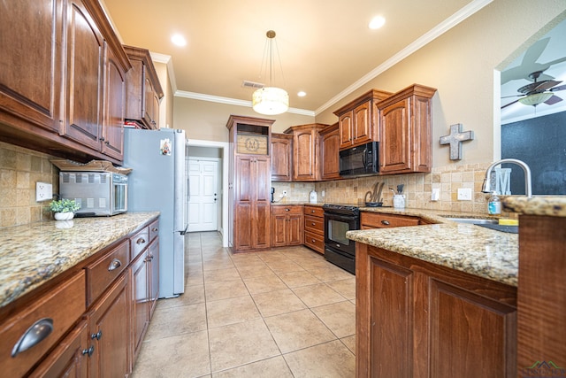 kitchen with ornamental molding, sink, black appliances, light tile patterned floors, and decorative light fixtures