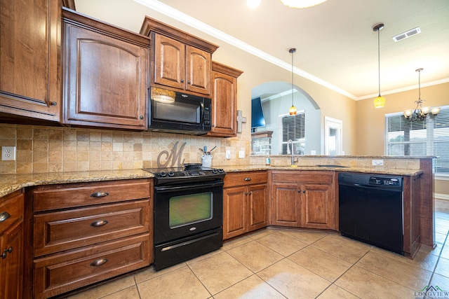 kitchen featuring light stone counters, crown molding, black appliances, pendant lighting, and an inviting chandelier