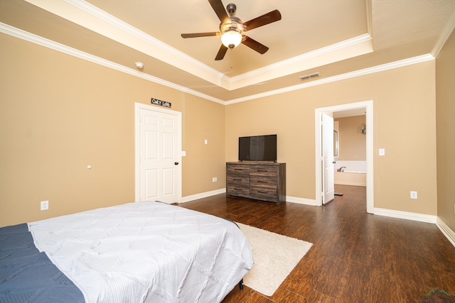 bedroom featuring ceiling fan, ornamental molding, dark wood-type flooring, and a tray ceiling