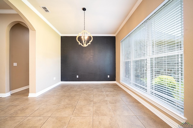 tiled spare room with crown molding and a notable chandelier