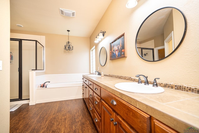 bathroom with wood-type flooring, vanity, and separate shower and tub