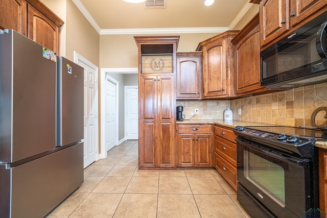 kitchen featuring backsplash, light stone counters, ornamental molding, black appliances, and light tile patterned floors