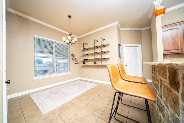 tiled dining area featuring crown molding and an inviting chandelier