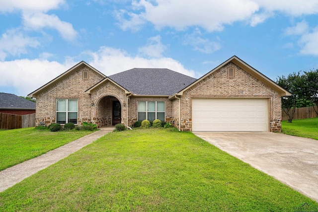 view of front of house with a front yard and a garage