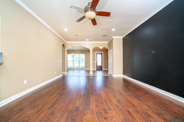 unfurnished living room with ceiling fan, dark hardwood / wood-style flooring, and ornamental molding