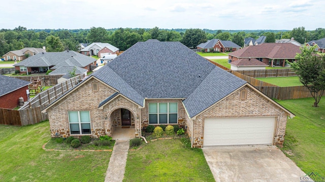 view of front facade with a garage and a front lawn