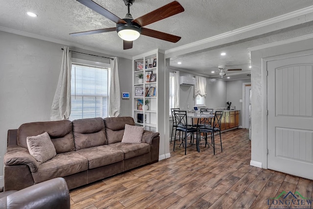 living area with crown molding, a ceiling fan, and a textured ceiling