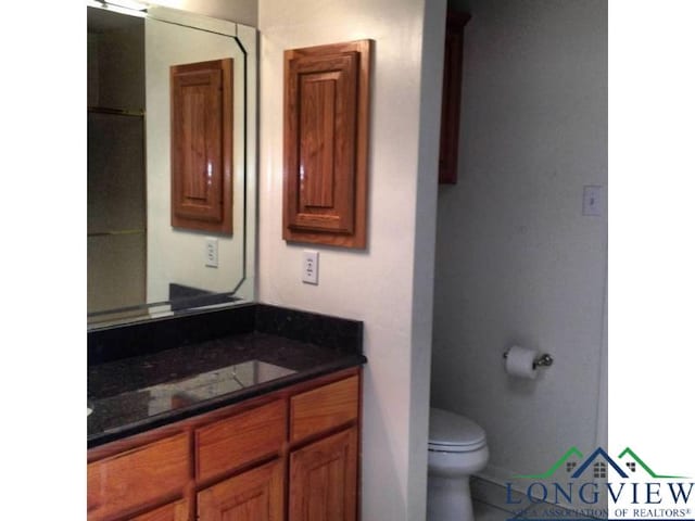 bathroom with vanity, toilet, and tile patterned floors