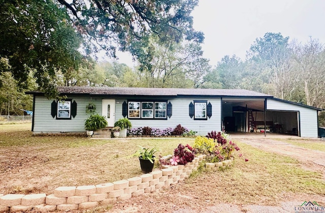 ranch-style home with a front lawn and a carport