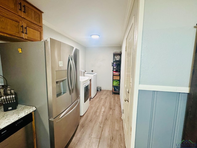 kitchen featuring light hardwood / wood-style floors, washer and clothes dryer, stainless steel appliances, and ornamental molding