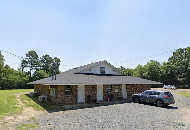2001 E 20th, Hooks, TX 75561 - view of front facade featuring covered porch, cooling unit, brick siding, and a shingled roof