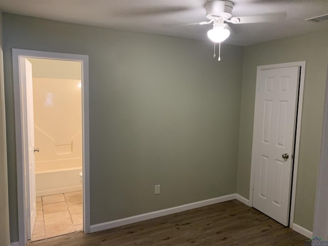 2001 E 20th, Hooks, TX 75561 - spare room featuring ceiling fan, dark wood finished floors, and baseboards