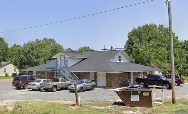 2001 E 20th, Hooks, TX 75561 - view of front facade featuring a shingled roof, brick siding, and stairs