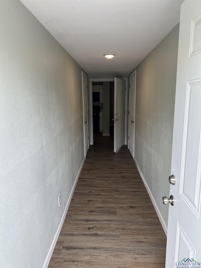 2001 E 20th, Hooks, TX 75561 - hallway featuring baseboards and wood finished floors