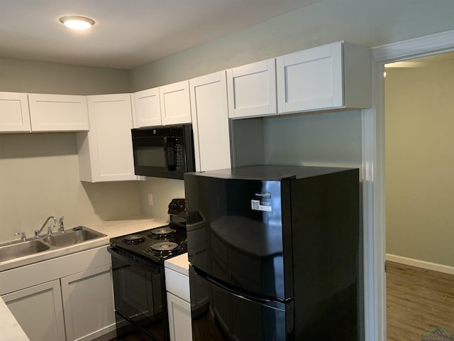 2001 E 20th, Hooks, TX 75561 - kitchen featuring black appliances, a sink, white cabinetry, light countertops, and dark wood-type flooring