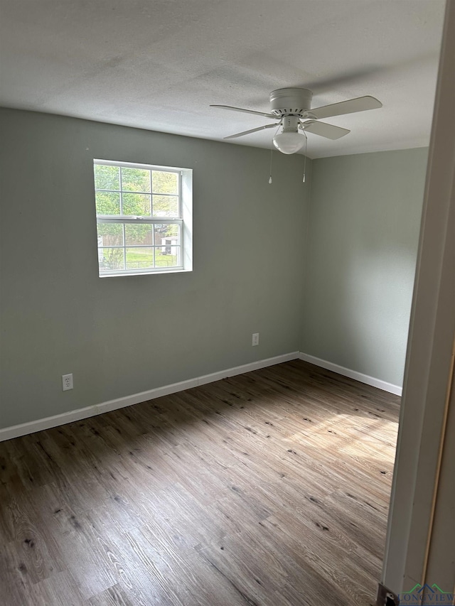 2001 E 20th, Hooks, TX 75561 - unfurnished room featuring ceiling fan, baseboards, and wood finished floors