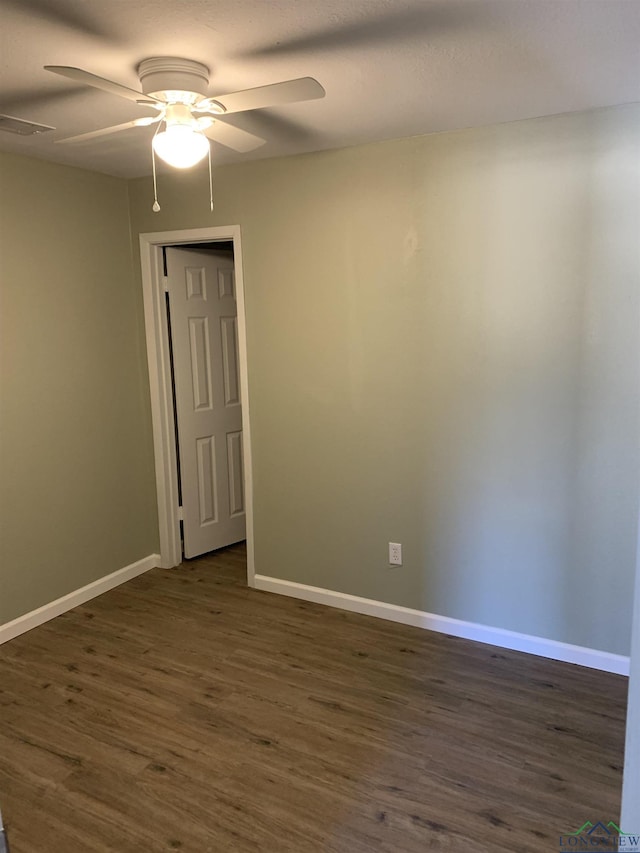 2001 E 20th, Hooks, TX 75561 - unfurnished room with ceiling fan, dark wood-style floors, and baseboards