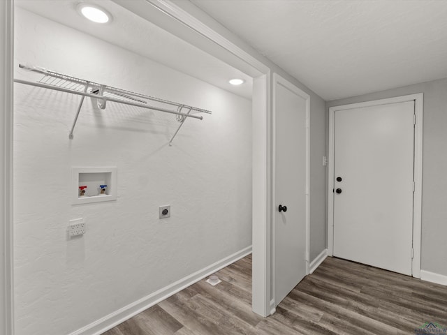 laundry room featuring washer hookup, hookup for an electric dryer, baseboards, and wood finished floors