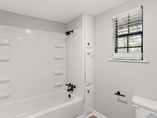 bathroom with  shower combination, baseboards, and toilet