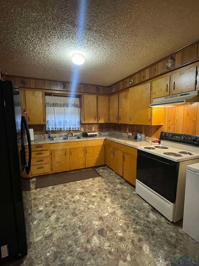 kitchen with electric stove, wood walls, freestanding refrigerator, and under cabinet range hood