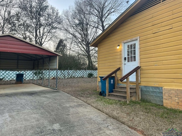 exterior space with entry steps, driveway, and fence