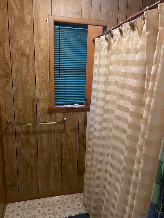 room details featuring wood walls and tile patterned floors