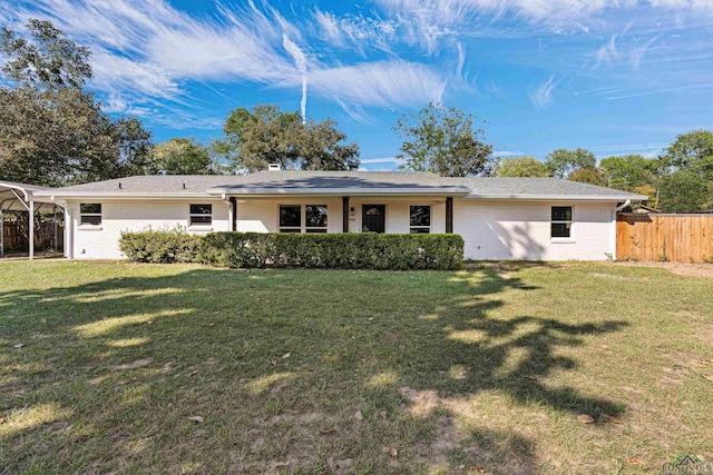 back of property featuring a lawn